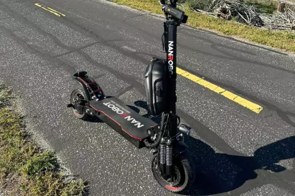 riding an electric scooter on the sidewalk